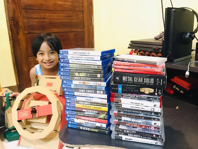 my son, Miggy, with my growing games collection